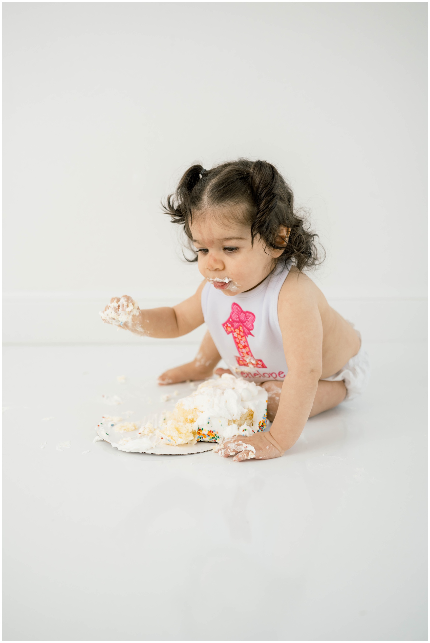 A baby girl smashes a cake on a studio floor before exploring birthday party venues in OKC