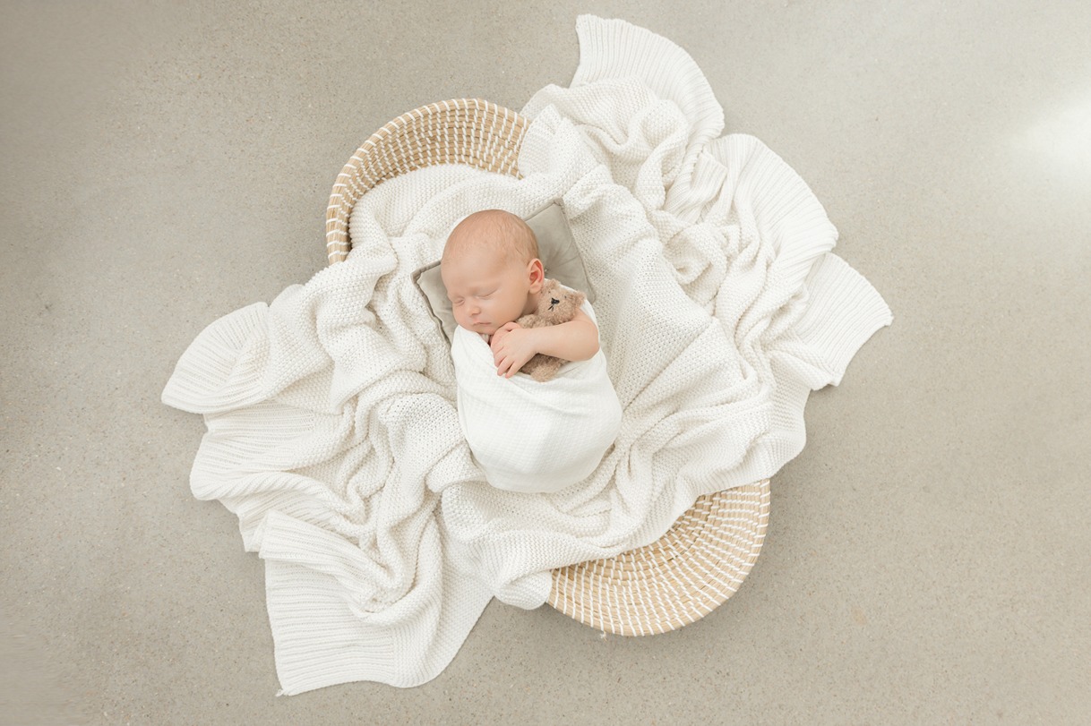 a baby wrapped in a blanket during the best time to take newborn pictures