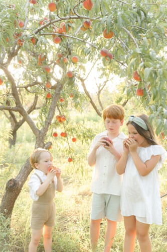 peach tree photo of the siblings holding peaches
